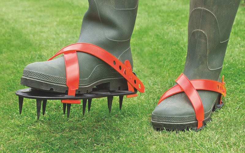 Welly boots with detachable lawn spikes for soil aeration 