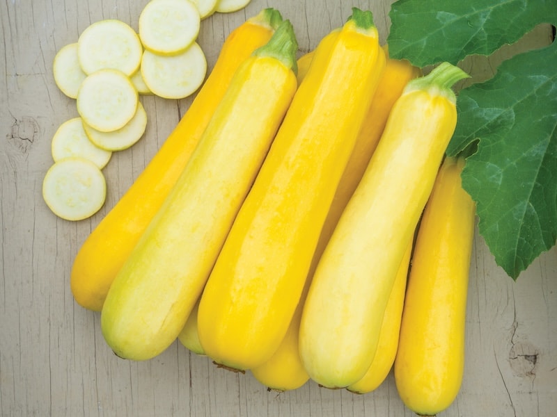 Bright yellow courgettes on table
