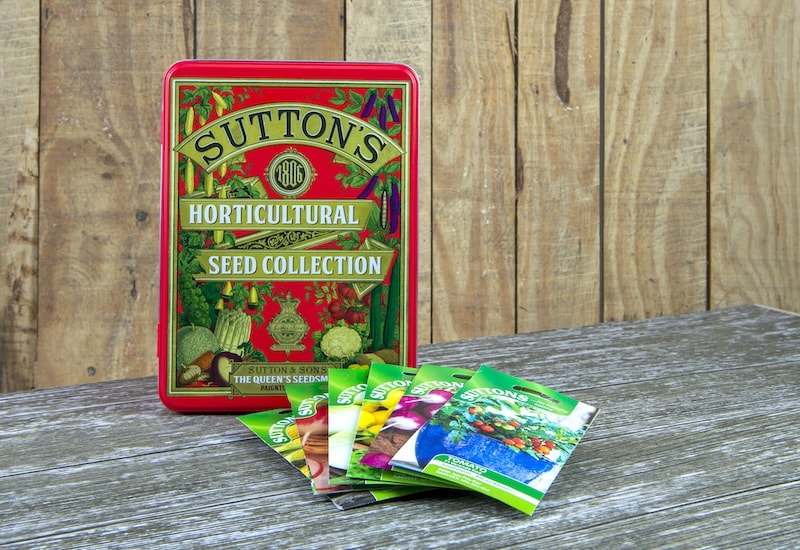 Suttons red tin with packets of seeds
