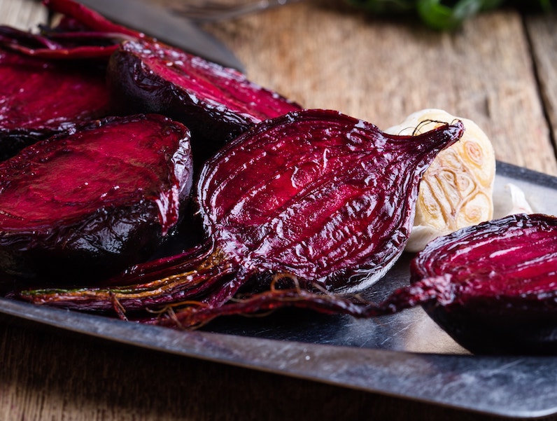 A roasted beetroot with garlic garnish 