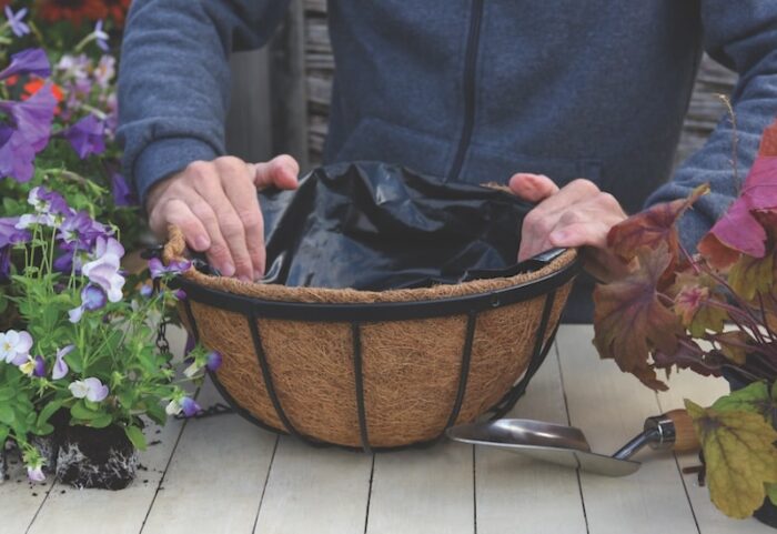 person-planting-up-hanging-basket-liner.jpg