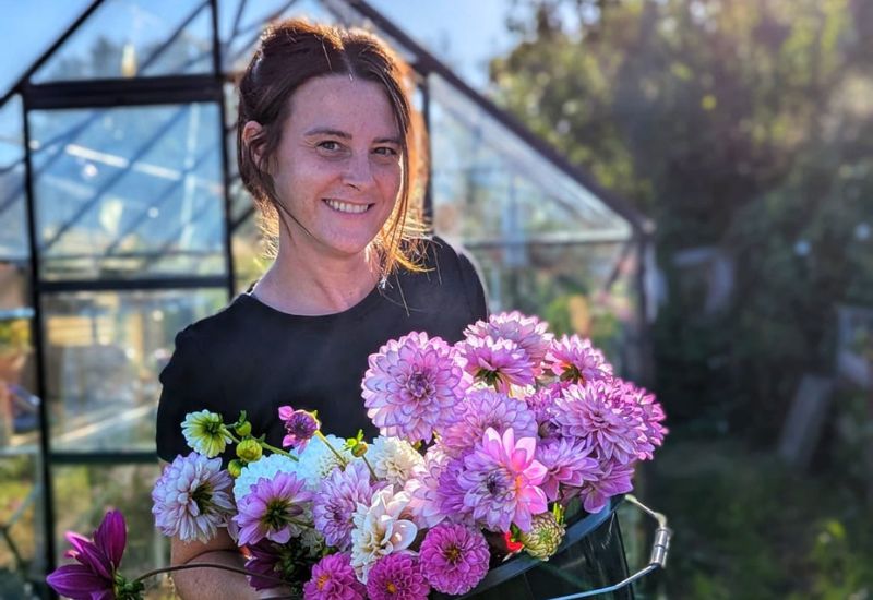 Jen, from @ life_on_the_lot holding a bucket of dahlias