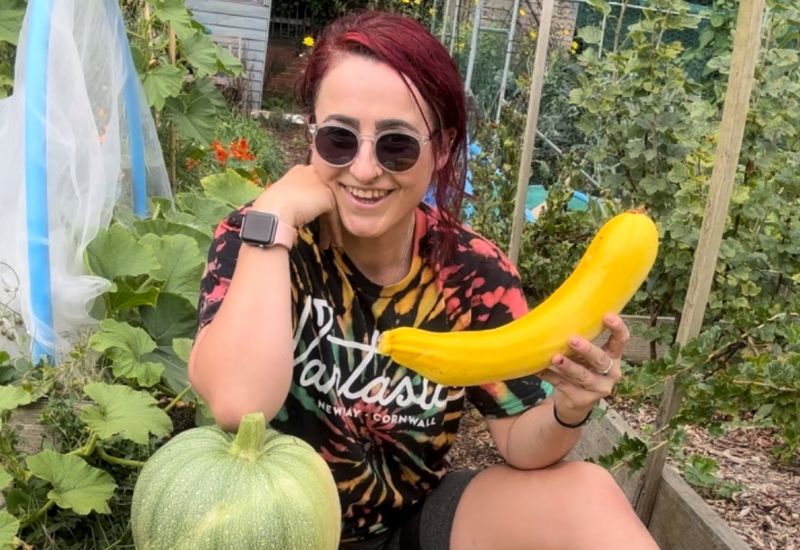 Stef holding homegrown courgette and squash
