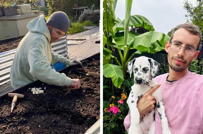 A gardener planting seeds in a raised bed and holding a Dalmatian puppy in a colourful garden.